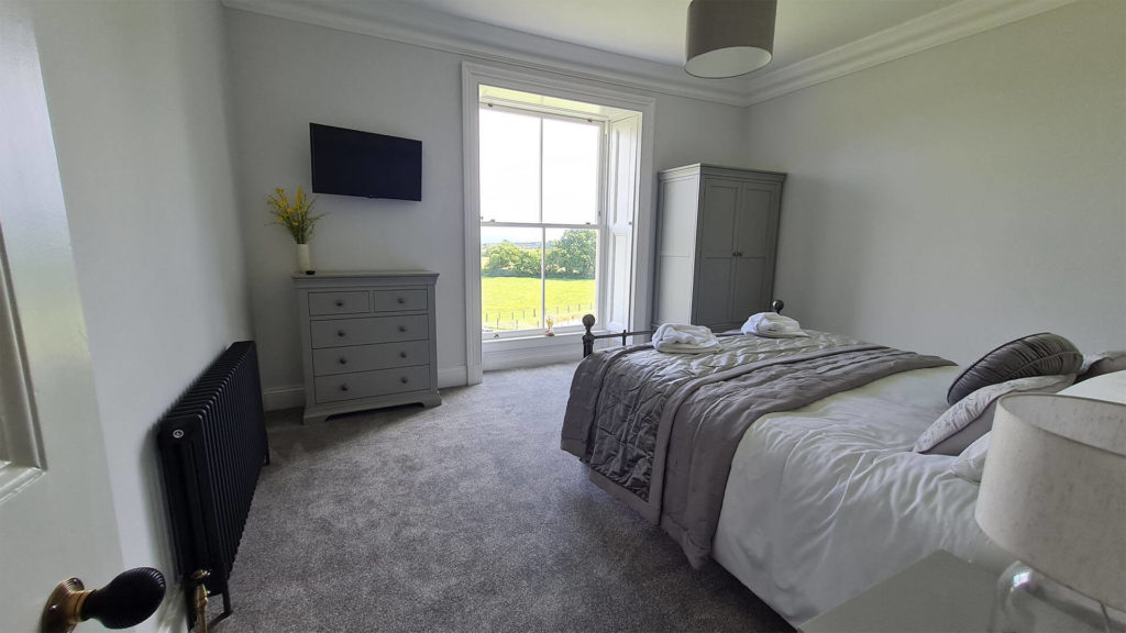 Restored country bedroom with heritage sash windows