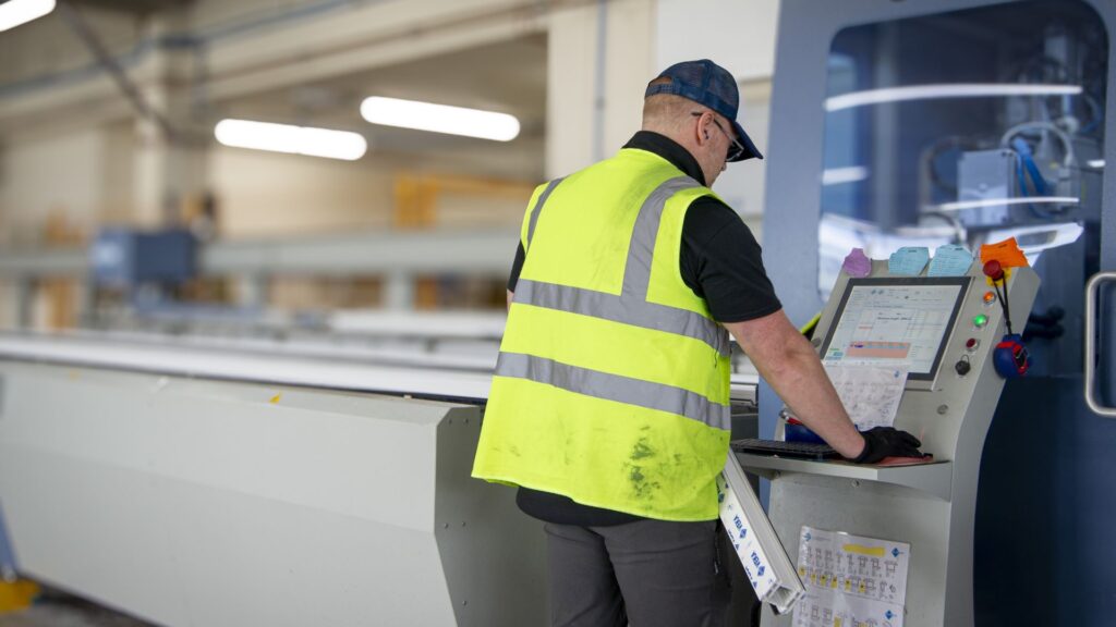 Fairco staff using a production machine
